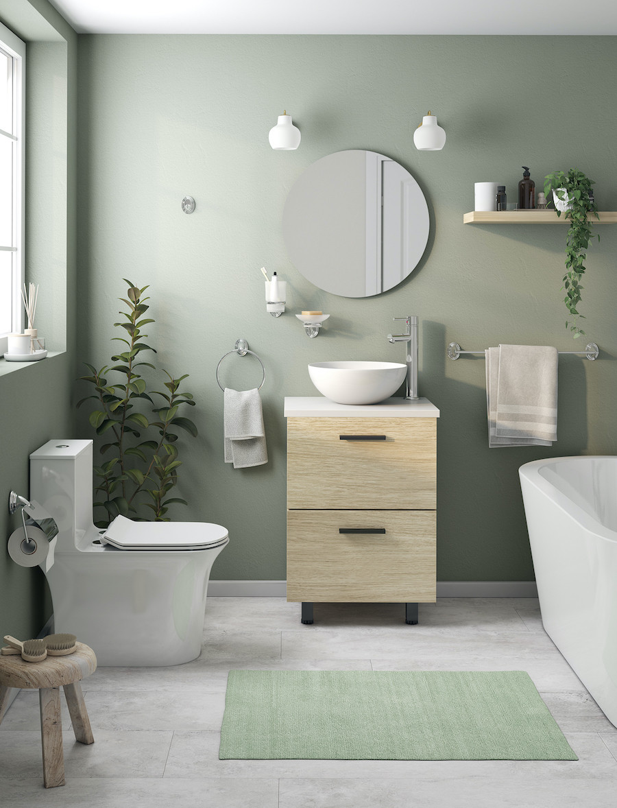 Baño con piso de porcelanato gris, muros verde olivo claro. Artefactos blancos y lavamanos con cajones de madera. Espejo redondo.