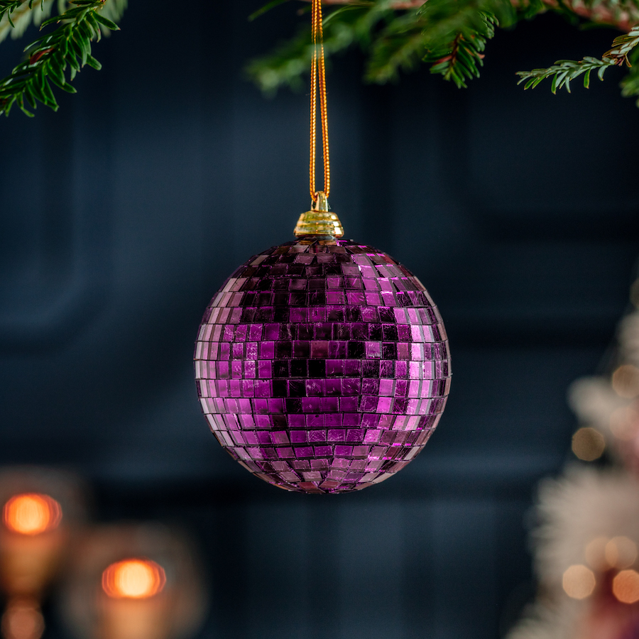 Adornos navideño con forma de bola disco morada.